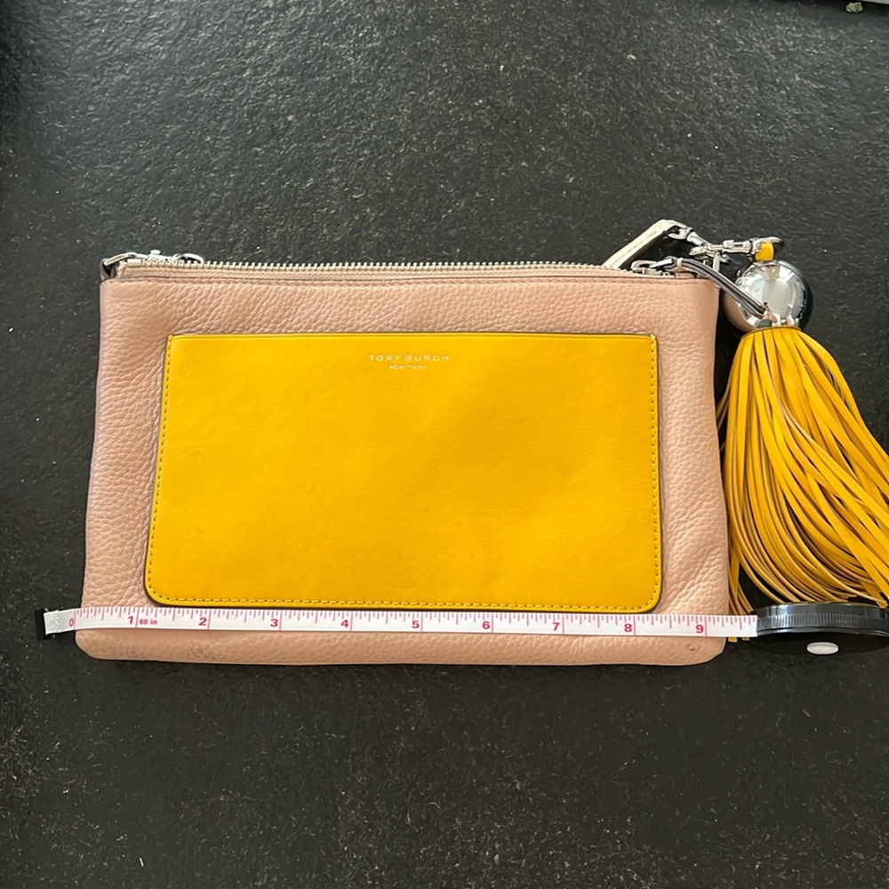 Tan yellow and white crossbody back by Tory Burch with large removable tassel